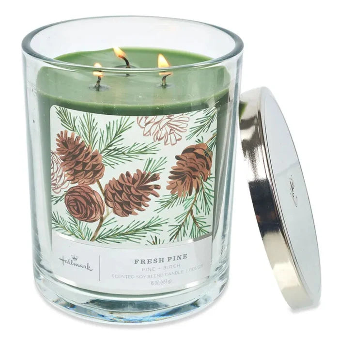 Hallmark Three-wick candle in a glass jar with a pine cone label on a white background