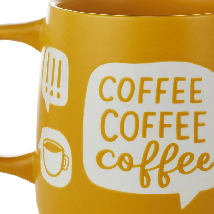 Yellow mug with 'COFFEE COFFEE coffee' text and speech bubble design on a white background