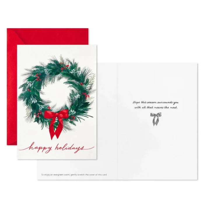 Christmas card with wreath and red bow on a white background