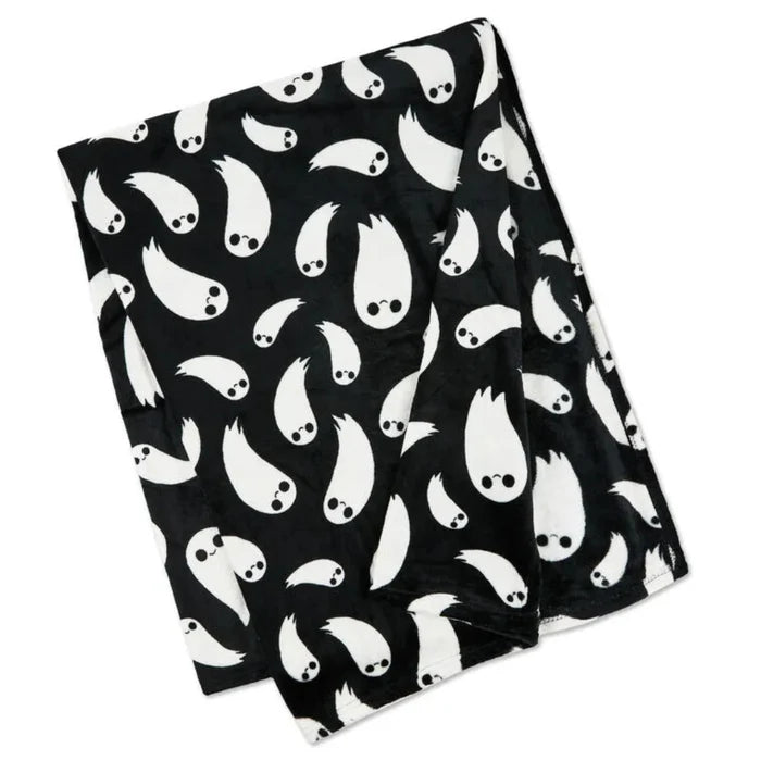 Black throw blacket with white ghost pattern on a white background