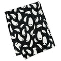Black throw blacket with white ghost pattern on a white background