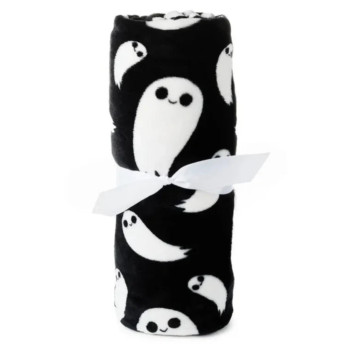 Folded black blanket with white ghost patterns on a white background