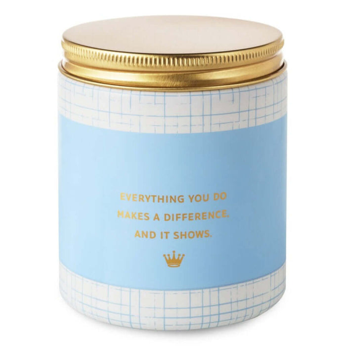 Candle jar with motivational quote " everything you do makes a difference, and it shows" on a white background