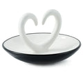 Side view Ring dish ceramic with arms that shape a heart. trinket dish on a white background.
