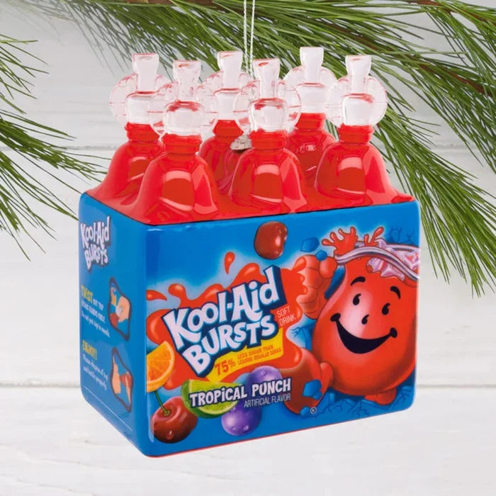 Kool-Aid Bursts Tropical Punch packaging ornament  hanging against a white background with greenery.