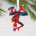 upside down Spider-Man Christmas ornament hanging on a tree branch