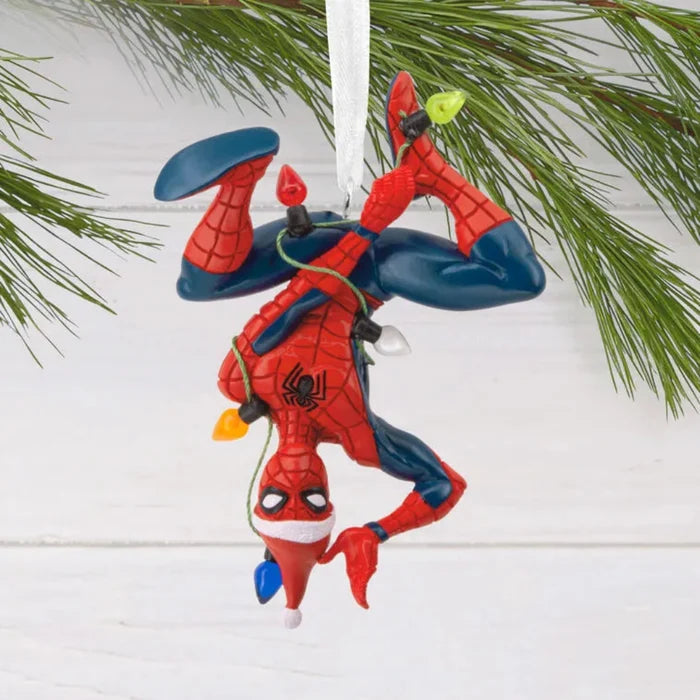 upside down Spider-Man Christmas ornament hanging on a tree branch