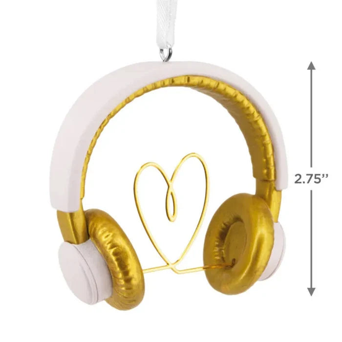 Gold and white headphones shaped like a heart with a measurement label on a white background