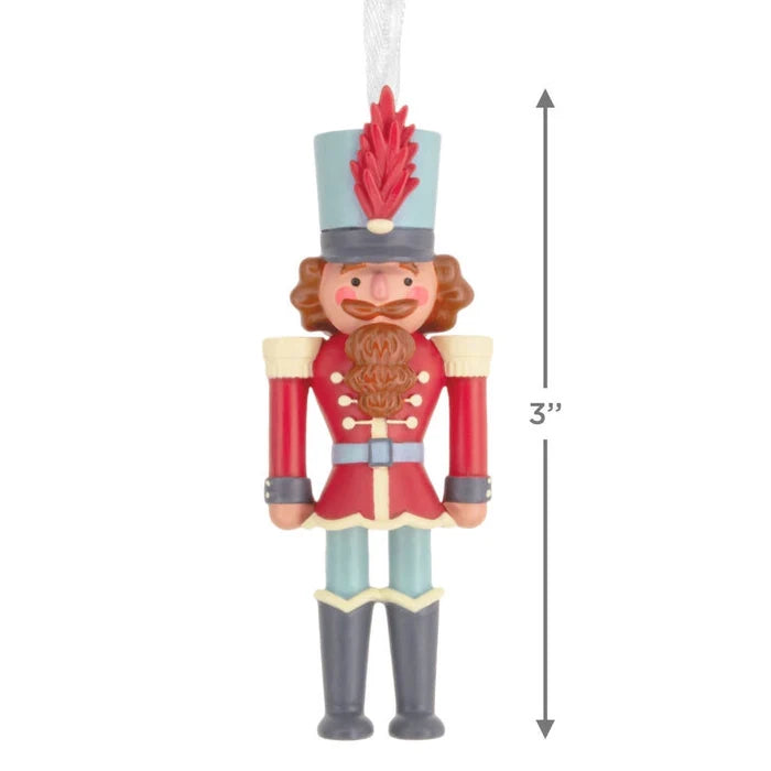 Decorative nutcracker ornament with measurement label on a white background
