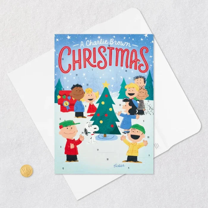 Charlie Brown Christmas card/ Advent Calendar with characters around a Christmas tree on a light blue background