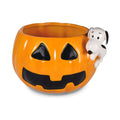 Pumpkin-shaped mug with snoopy figurine on a white background