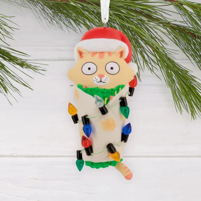 Cat Christmas ornament with lights and Santa hat on a branch on a festive  background