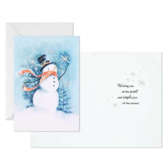 Greeting card with a snowman design and winter scenery on a white background