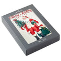 Gray box with a Christmas card featuring Santa Claus holding a tree and a sack.