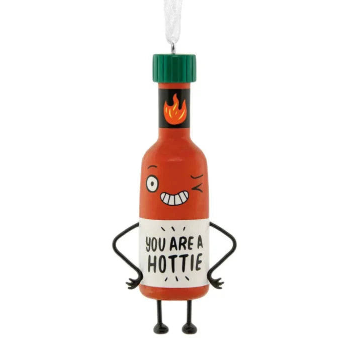 Decorative hot sauce bottle ornament with cartoon face and text 'You are a hottie' on a white background