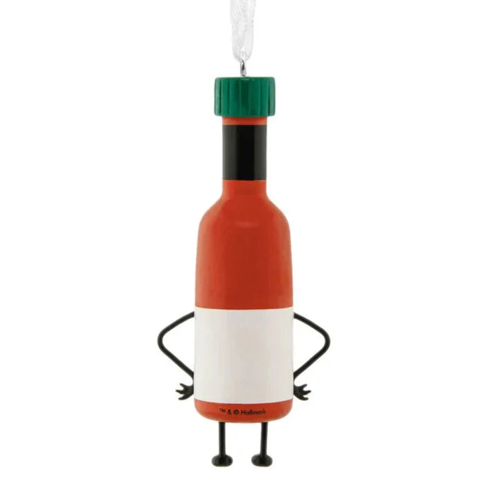 Animated hot sauce bottle ornament with arms and legs on a white background