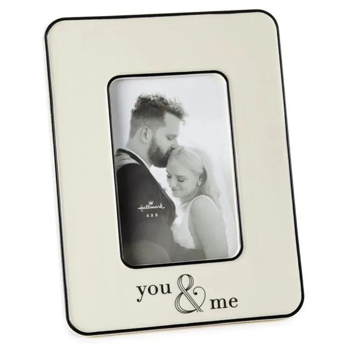 Cream colored photo frame with 'you & me' text and a couple's picture inside, on a white background.