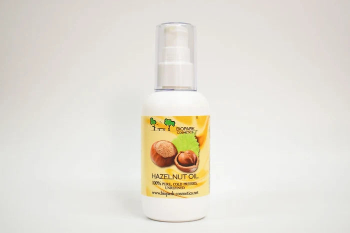 Bottle of hazelnut oil with a yellow label on a white background