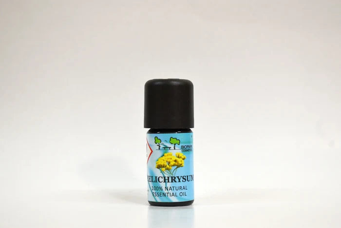 Bottle of Helichrysum essential oil on a white background