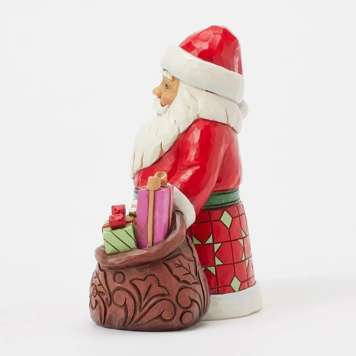 Side view showing hand-carved patterns and Santa’s red coat.