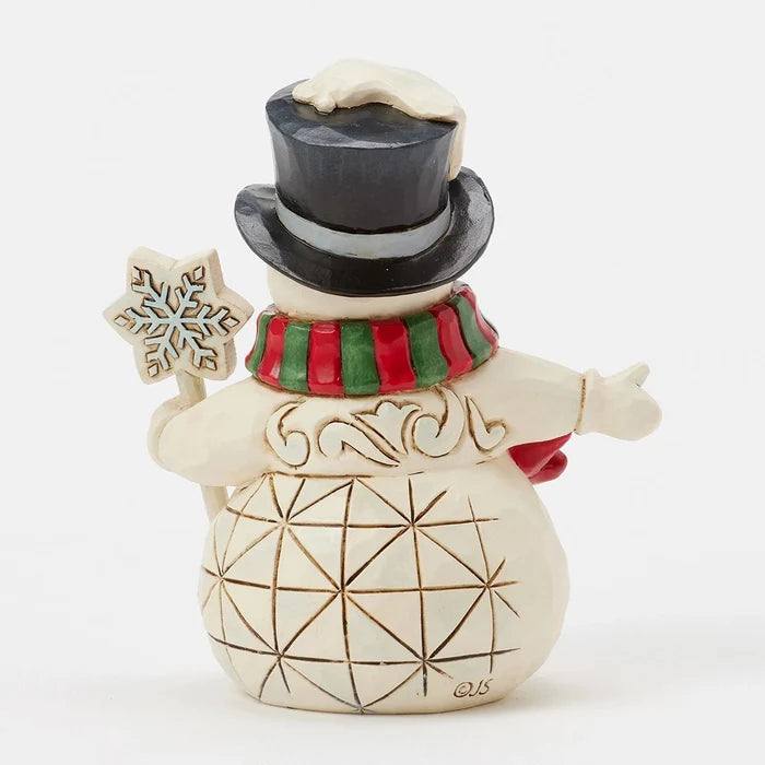 Back view showing hand-carved details and red-green scarf.