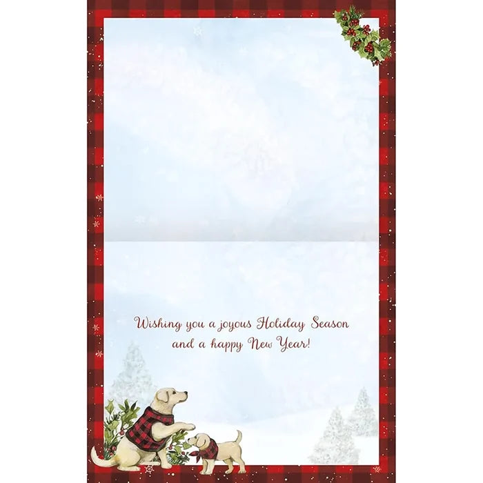 Holiday card with two dogs in plaid jackets and a snowy landscape.
