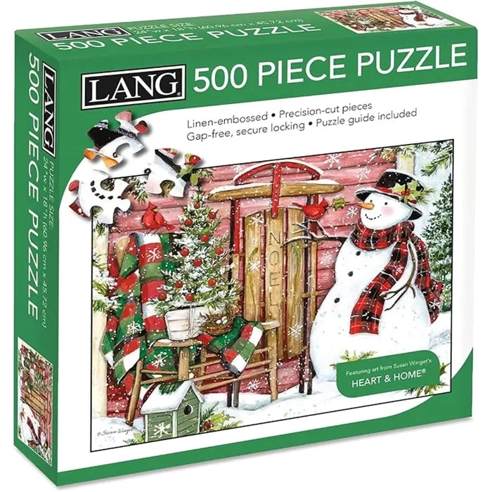 Jigsaw puzzle box with a snowman and festive scene, featuring the LANG brand.