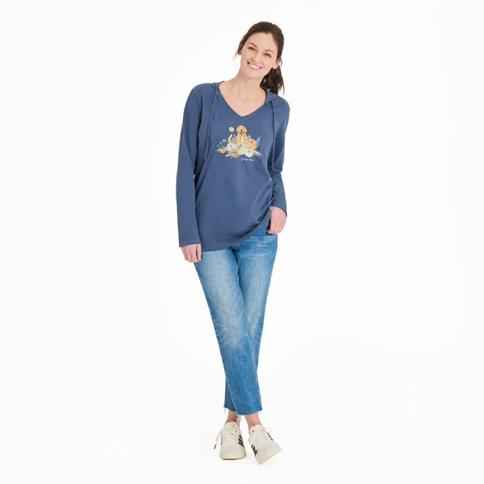 Woman wearing a blue long-sleeve shirt with a graphic design on a white background