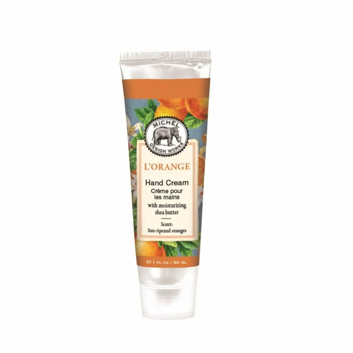 A tube of Michel Design Works L'Orange hand cream with shea butter, featuring an orange and leaf design on the label.