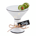 Decorative ceramic martini glass with olives and 'Dirty' label on a white background
