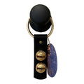 Black keychain with gold accents and a purple tag on a white background