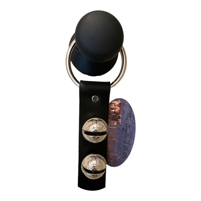 Black leather keychain with metallic accents on a white background