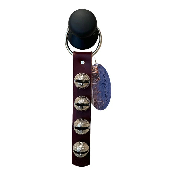Black bell with leather strap and metal bells on a white background