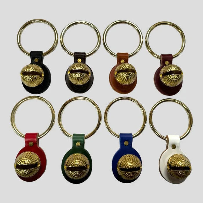 Set of keychains with gold bell designs on a white background