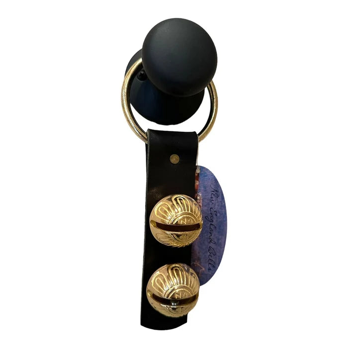 Black and gold baby rattle with a visible brand logo on a white background