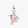 Pink turtle charm with a star detail on a white background