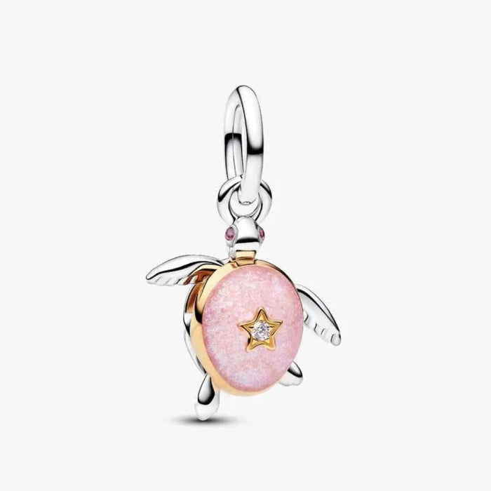 Pink turtle charm with a star detail on a white background