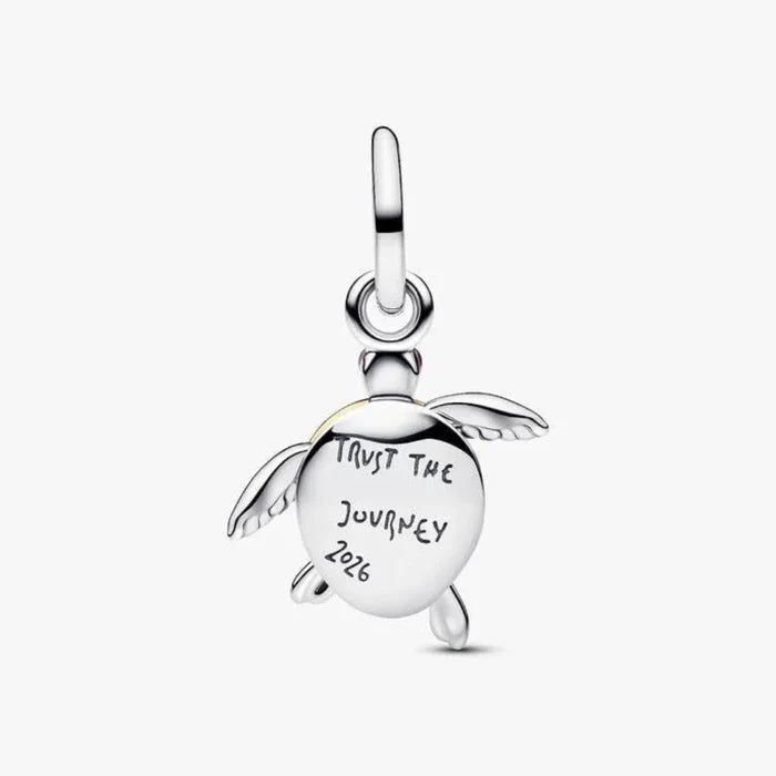 Silver turtle charm with 'Trust the Journey 2026' engraving on a white background