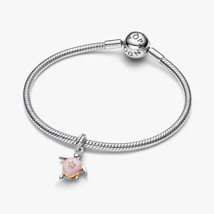 Silver bracelet with a pink charm on a white background