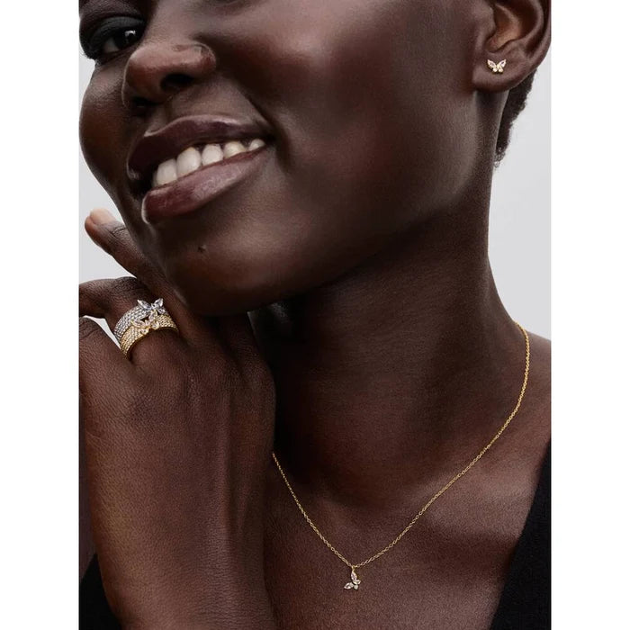 Woman wearing Pandora Butterfly Gold Pendant Necklace with matching butterfly earrings and rings.