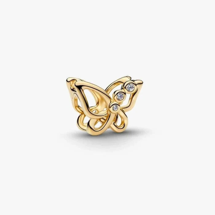 Golden butterfly-shaped charm on a light background