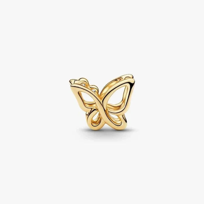 Golden butterfly-shaped charm on a light background