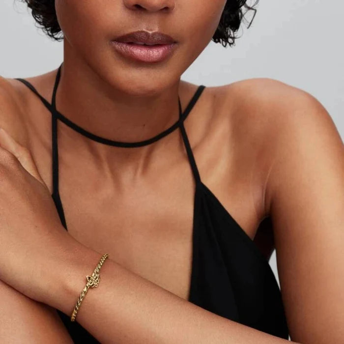 Golden bracelet with a butterfly charm on the wrist