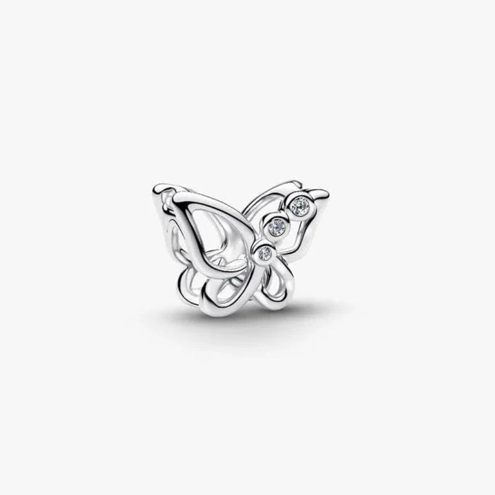 Silver butterfly charm with clear gemstones on a white background