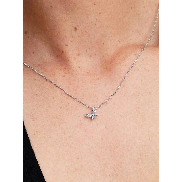 Model wearing the PANDORA Butterfly Pendant Necklace, showing the clear crystal butterfly pendant resting elegantly on the neckline.