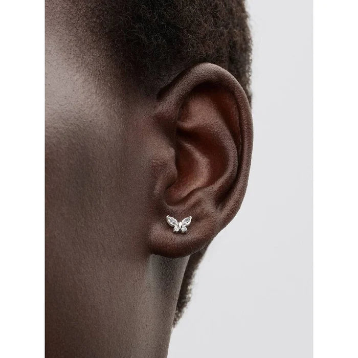 Pandora clear butterfly stud earrings worn on ear with sparkling cubic zirconia stones