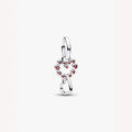 Silver heart with red gemstones on a light background