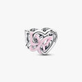 Silver heart and butterfly shaped charm on a light background