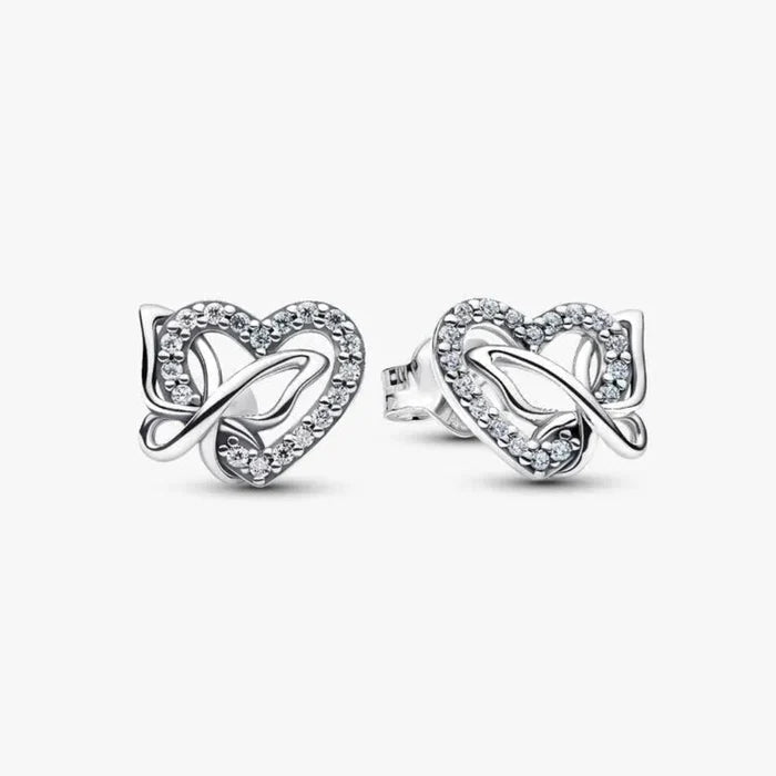 Silver earring with a heart and butterfly shaped charm on a white background