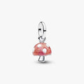 Mushroom-shaped charm with red and white polka dot design on a white background